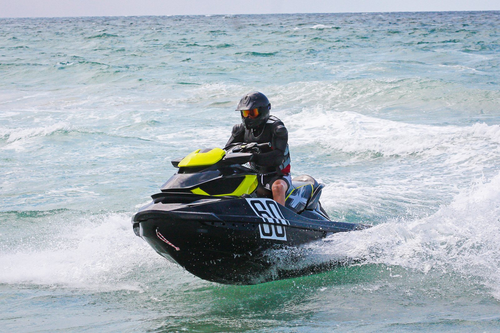 Jet Ski. Young Man on Jet Ski. Professional jet ski rider. Jet Ski Championship. Jetski performs many tricks on the waves.